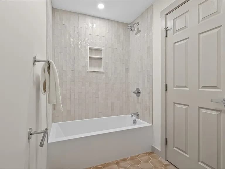 Renovated bathroom with vertical-stack tile and soaker tub at 79 Fox Street Worcester