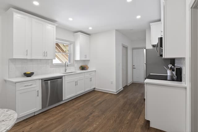 Renovated kitchen with white shaker cabinets and quartz counters at 79 Fox Street Worcester